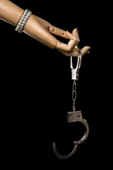 Fotobehang Hand of woman offers handcuffs. Love or jail. Isolated on black background. Studio Shot. With copy space text. © Serge Aubert