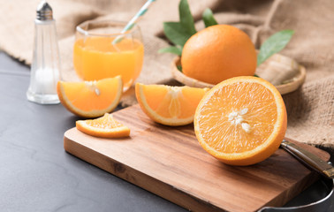 Fresh sliced orange on wood plate
