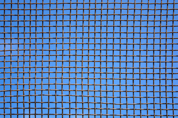 Photo of steel mesh wall on sky background