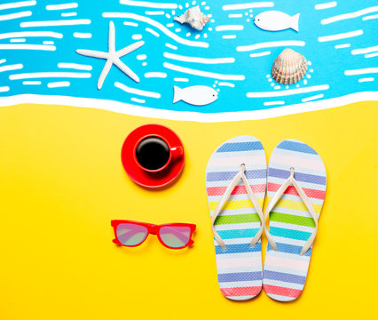 Summertime flip-flops and coffee cup with sunglasses