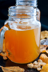Lager beer and snacks on stone table. Nuts, chips.