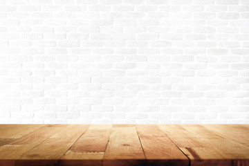 Wood table top on white brick wall background