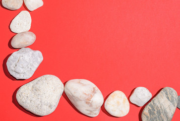 White pebbles on red paper, background