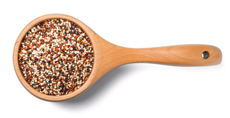 uncooked quinoa in the wooden spoon, isolated on white, top view