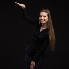 Young happy woman showing presentation, pointing on placard over