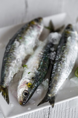 Fresh raw fish on wooden board. Background. From above