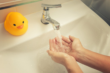 Washing your hands from the sink faucet.