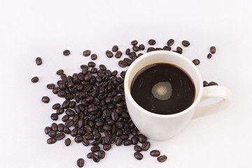 Coffee cup and beans on white background.