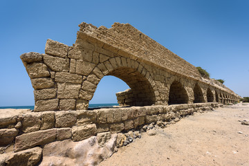 Ancient Roman aqueduct in Ceasarea at the coast of the Mediterranean Sea, Israel