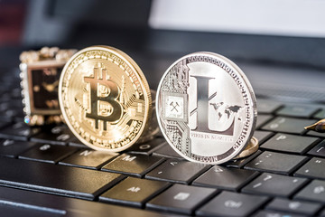 bitcoin and litecoin on black laptop keyboard