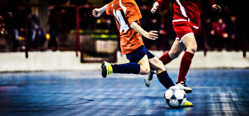 Five a side football player kicking the ball