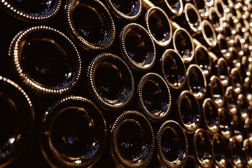 Stacked aging wine bottles in modern cellar