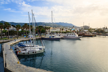 Fototapeta premium Yacht marina and ferries terminal of Kos town in greece islands of aegean sea. View from above on turquoise water surface of Kos port.