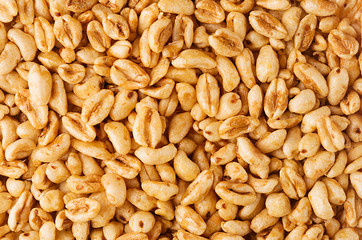 Puffed honey air rice wheat closeup background. Cereals texture.