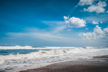 Beautiful Sea Splashing Wave on the Beach with Blue Sky Background. Tropical Nature Background. Paradise Sea Beach Island. Clean Ocean Dynamic Waves. Beach Landscape View. Sea Tropical Background
