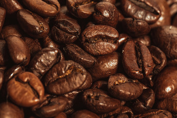 Dark many roasted coffee beans texture background