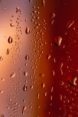 Drops on the glass rain red background