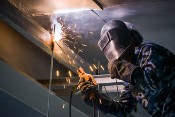 Arc welding of a steel in construction site - obrazy, fototapety, plakaty