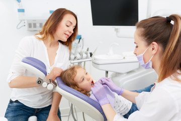 Fototapeta premium Dentists making treatment for little girl
