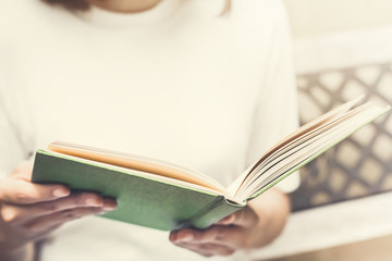 Woman reading book on the bench,