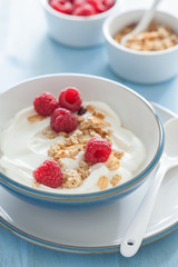 yogurt with granola and raspberry for healthy breakfast