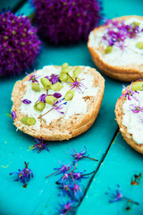 Closeup of flowering chives with shallow depth of field and focus concentrated on flower in the foreground