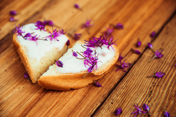 Closeup of flowering chives with shallow depth of field and focus concentrated on flower in the foreground