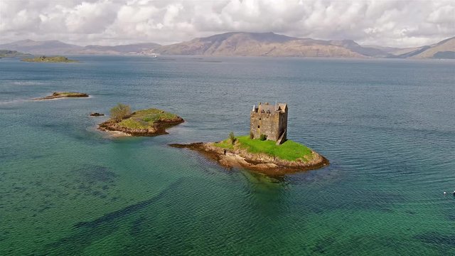 Aerial shot of medieval Castle Stalker on the west coast of Scotland by Appin