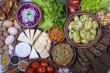 Assortment of cooked food and vegetables on the background. Top view, close up