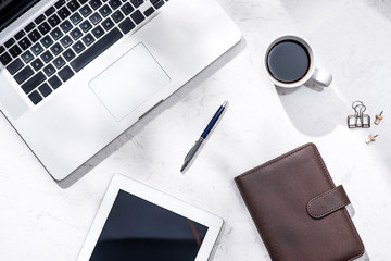 Flat lay, top view of laptop and other supplies.