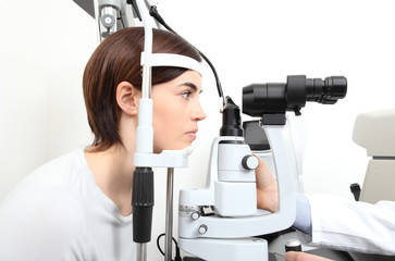 woman doing eyesight measurement with optician slit lamp