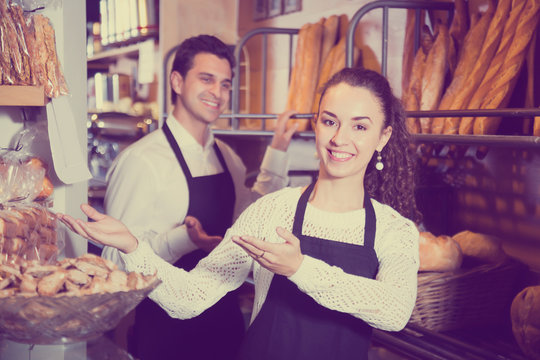 Man and girl selling pastry and loaves