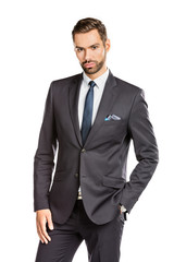 Handsome young businessman standing confident on white background