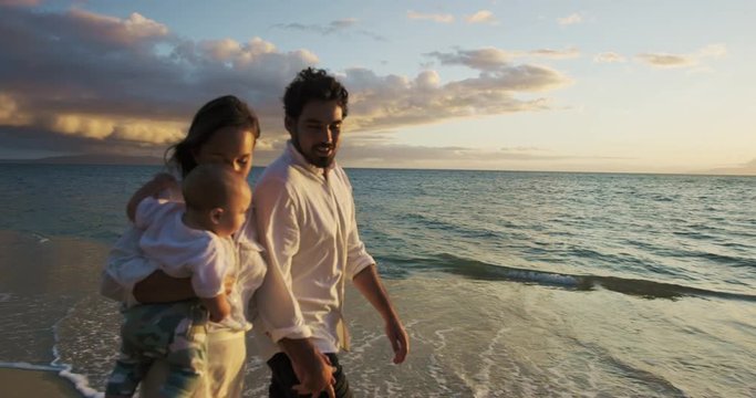 Happy family having fun outdoors at the beach at sunset. Baby Milestones