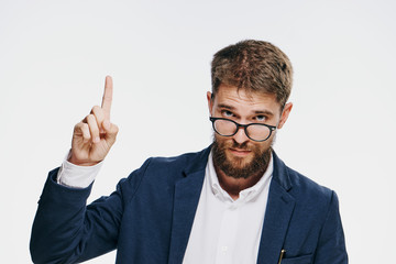 Business man with glasses, business man showing his finger on empty space, businessman on light background 