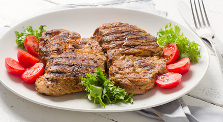 Grilled pork steak and vegetable salad