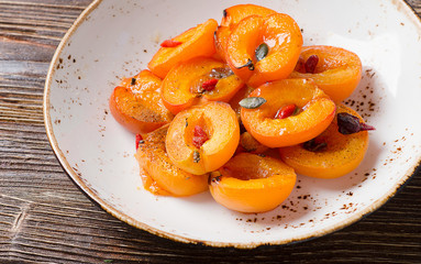 Baked apricots in bowl.