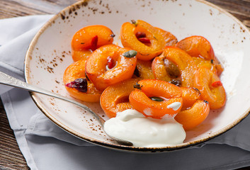 Baked apricots in bowl.