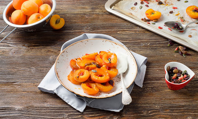 Baked apricots in bowl.