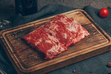 Raw meat in wood background