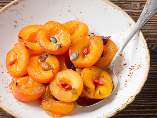 Baked apricots in bowl.