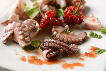 Octopus with seasoning on white dish © al62