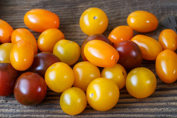 Cherry tomatoes on rustic wooden background
