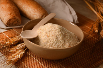 Bread crumbs in the bowl on the wooden table