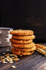 Oat cookies on a old black wooden background.