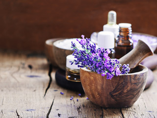 Lavender spa , bunch of lavender flowers , essential oil and salt on a rustic wooden background. - obrazy, fototapety, plakaty