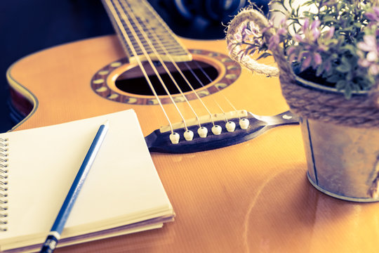 Guitar and notebook for love writing equipment with flower bucket.