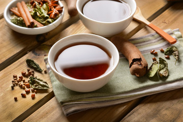 relaxing herbal tea in the bowl with ingredients around