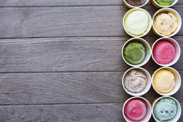 Top view Ice cream flavors in cup on wood table