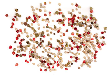 Black, red, green, white peppercorns isolated on white background. Heap of spice. Mix of different peppers. Top view